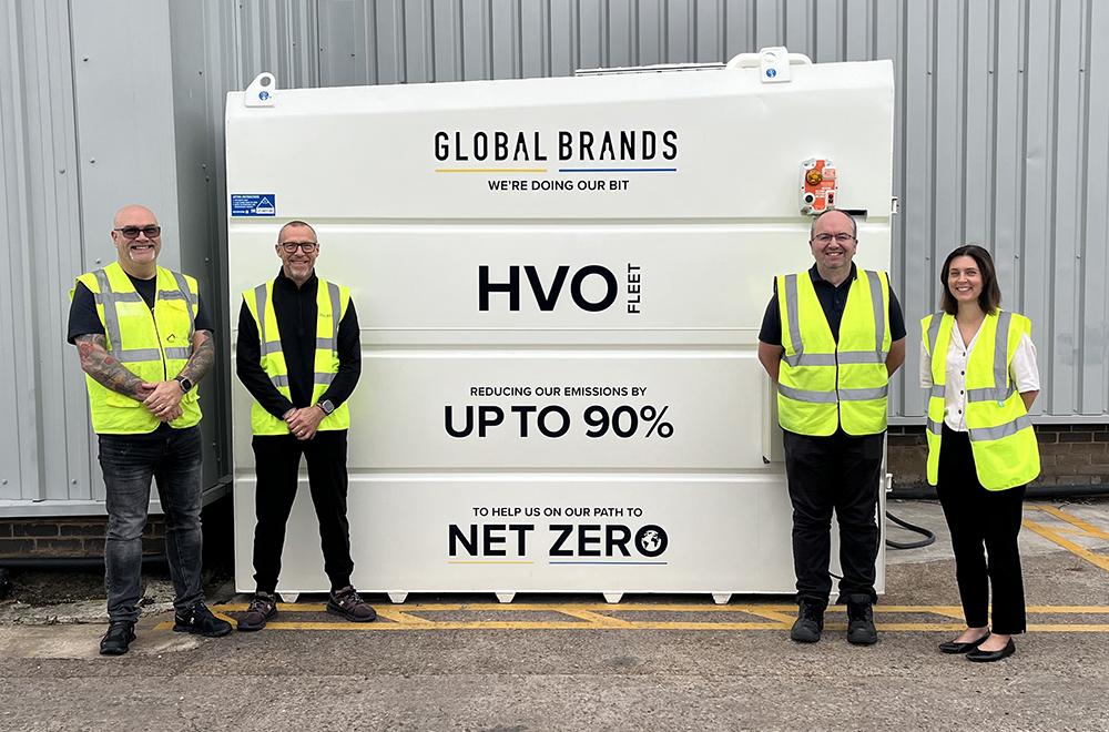 Global Brands staff in front of HVO tank