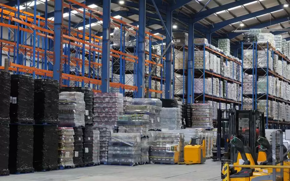 Palettes stacked in Global Brands' warehouse, with newly installed lighting shining above